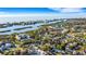 Aerial view of a home near the water, showcasing the surrounding neighborhood and waterfront at 14462 91St Ave, Seminole, FL 33776