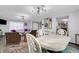 Open concept dining room with white table and chairs, adjacent to living area at 14462 91St Ave, Seminole, FL 33776