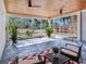 Spacious covered patio with screened walls, tile floor, and seating area at 16434 Redington Dr, Redington Beach, FL 33708