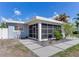 Mid-century modern home with screened porch and walkway at 16434 Redington Dr, Redington Beach, FL 33708