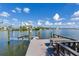 Relaxing waterfront dock with seating area and boat lift at 16434 Redington Dr, Redington Beach, FL 33708