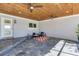 Covered patio with wood ceiling, tile floor, and outdoor seating at 16434 Redington Dr, Redington Beach, FL 33708