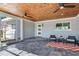 Covered patio with wood ceiling, tile floor, and outdoor seating at 16434 Redington Dr, Redington Beach, FL 33708