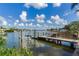 Private dock with boat lift offers scenic waterfront views at 16434 Redington Dr, Redington Beach, FL 33708