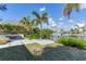 Landscaped backyard with patio, seating, and water views at 16434 Redington Dr, Redington Beach, FL 33708