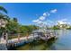 Wooden dock extending over calm water with a seating area at 16434 Redington Dr, Redington Beach, FL 33708
