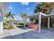 Covered outdoor kitchen with grill, sink, and bar seating at 16434 Redington Dr, Redington Beach, FL 33708
