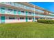 Two-story building with teal accents and a manicured lawn at 1950 59Th N Ave # 114, St Petersburg, FL 33714
