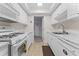 Efficient galley kitchen with white cabinets and gas stove at 1950 59Th N Ave # 114, St Petersburg, FL 33714