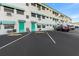 Exterior view of a two-story building with teal accents and ample parking at 1950 59Th N Ave # 114, St Petersburg, FL 33714