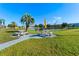 Picnic tables and a yellow umbrella near a pond at 1950 59Th N Ave # 114, St Petersburg, FL 33714