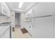 White kitchen features granite countertops and updated appliances at 1950 59Th N Ave # 114, St Petersburg, FL 33714