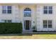 Front entrance of a two-story house with a dark brown door and arched window at 2012 Deltona Blvd, Spring Hill, FL 34606