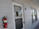 Front door of an apartment unit with a fire extinguisher at 2100 World Parkway Blvd # 58, Clearwater, FL 33763
