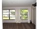 Spacious living room featuring large windows and neutral carpeting at 2100 World Parkway Blvd # 58, Clearwater, FL 33763