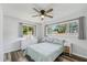 Bedroom with a queen bed, window, ceiling fan, and light wood flooring at 2233 6Th Sw Ave, Largo, FL 33770