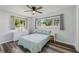 Bedroom with a queen bed, window, ceiling fan, and light wood flooring at 2233 6Th Sw Ave, Largo, FL 33770