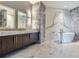Elegant bathroom with double vanity, soaking tub, and marble tile at 2912 W Santiago St # 2204, Tampa, FL 33629