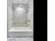 Clean bathroom with a shower/tub combo and marble tile surround at 2912 W Santiago St # 2204, Tampa, FL 33629