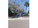 Small light-grey house with mature trees in the front yard at 321 77Th Ave, St Pete Beach, FL 33706