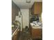 Kitchen with wooden cabinets, appliances, and cluttered counters at 321 77Th Ave, St Pete Beach, FL 33706