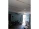 Living room with door to exterior and cluttered floor at 321 77Th Ave, St Pete Beach, FL 33706