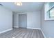 Bedroom with grey walls and vinyl flooring and double closet at 4010 Leonard St, Valrico, FL 33594