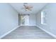 Bedroom with gray flooring, barn door, and access to bathroom at 4010 Leonard St, Valrico, FL 33594