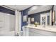 Double vanity bathroom with navy walls and a shower/tub combo at 4624 Coastal Storm Gln, Palmetto, FL 34221