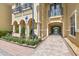 Inviting clubhouse entrance with archways and landscaping at 5228 Hampton Beach Pl # 140, Tampa, FL 33609