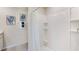 Clean bathroom with shower/tub combo and built-in shelving at 5905 Silver Moonlight Dr, Palmetto, FL 34221