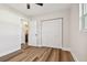 Bedroom featuring wood-look floors, closet, and access to bathroom at 5908 S Manhattan Ave, Tampa, FL 33616