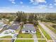 Aerial view of home situated with a manicured front lawn, and mature trees in a residential neighborhood at 5908 S Manhattan Ave, Tampa, FL 33616