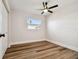 Simple bedroom with wood-look floors and a ceiling fan at 5908 S Manhattan Ave, Tampa, FL 33616