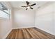 Well-lit bedroom with wood-look floors and ceiling fan at 5908 S Manhattan Ave, Tampa, FL 33616