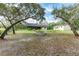 Large backyard with mature trees and a garden at 7094 Juniper Ave, Webster, FL 33597