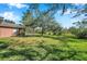 Large backyard, partially shaded, with home view at 7753 Foxgrove Dr, Land O Lakes, FL 34637