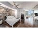 Spacious bedroom with brick feature wall, modern ceiling fan, and ensuite bathroom access at 777 N Ashley Dr # 1808, Tampa, FL 33602