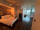 Open concept bedroom with city views and a brick feature wall at 777 N Ashley Dr # 1808, Tampa, FL 33602