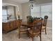 Bright dining room featuring a wood table and chairs, buffet, and window with plantation shutters at 7861 38Th N Ter # 7861, St Petersburg, FL 33709