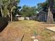 Expansive backyard with trees and a partial fence, offering potential for landscaping and outdoor enjoyment at 1003 W Mahoney St, Plant City, FL 33563