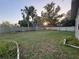 Large, grassy backyard enclosed by a wooden fence, providing ample space for recreation and outdoor activities at 1003 W Mahoney St, Plant City, FL 33563