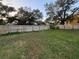 Spacious backyard with a well-maintained lawn and a wooden fence, creating a private and inviting outdoor space at 1003 W Mahoney St, Plant City, FL 33563