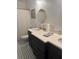 Bathroom featuring double vanities, dark wood cabinets, and tiled floors at 1003 W Mahoney St, Plant City, FL 33563