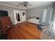 Bedroom with hardwood floors, ceiling fan, gray walls, and built-in storage cabinets at 1003 W Mahoney St, Plant City, FL 33563
