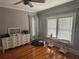 Bedroom featuring hardwood floors, gray walls, and bright window light at 1003 W Mahoney St, Plant City, FL 33563