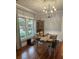 Cozy dining area featuring hardwood floors, contemporary lighting, and a view of the outdoor landscape at 1003 W Mahoney St, Plant City, FL 33563