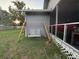 Exterior detail of a cozy porch swing and screened porch area, perfect for enjoying peaceful outdoor moments at 1003 W Mahoney St, Plant City, FL 33563