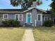Charming home featuring a bright turquoise door, neat landscaping, and a welcoming walkway at 1003 W Mahoney St, Plant City, FL 33563