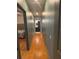 Hallway featuring hardwood floors that leads to the bathroom and a bedroom at 1003 W Mahoney St, Plant City, FL 33563